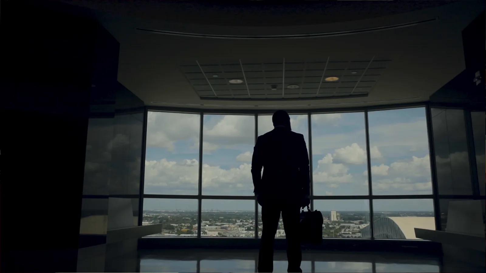 Silhouette of Attorney Quinton A. R. Brooker at a window, from the QB Law brand film
